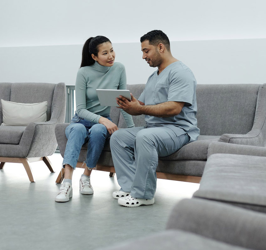 Doctor explaining to a patient using iPad computer