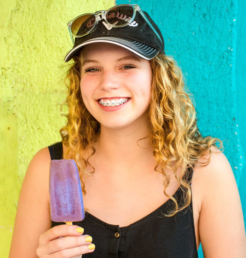 Young woman with invisalign braces eating ice cream