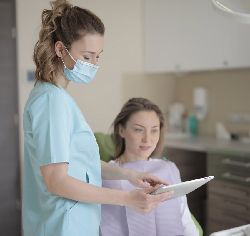 Dentist doctor with tablet computer explaining to patient